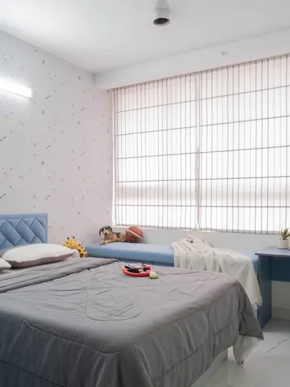 The kid's room includes a functional study desk and chair, with plenty of natural light from the large window.