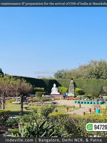 A wide view of the gardens at Manekshaw Centre, featuring a large Buddha statue, manicured hedges, and potted plants. This showcases the scale of the commercial landscaping projects I undertake.