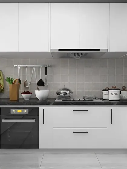 A clean and minimalist all-white U-shaped kitchen. The simple design with handleless cabinets and a dark countertop creates a bright and spacious feel, perfect for smaller homes.