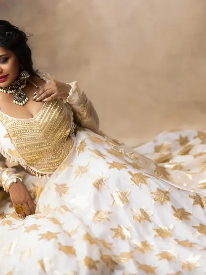 The full view shows how this contemporary jewellery pairs beautifully with a white and gold lehenga for a high-fashion look.