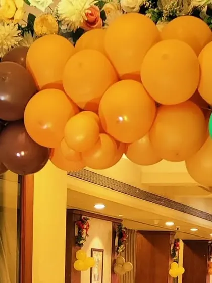 A close-up view of a balloon arch with a unique color combination of brown, orange, and green. This type of organic color palette can be used for jungle-themed parties or rustic-themed events.