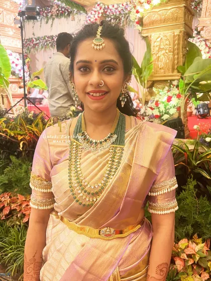 A candid shot from the wedding venue. The makeup looks fresh and natural, perfect for a long day of festivities.