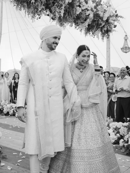 A black and white version of Manchal and Luca's joyful exit, emphasizing the emotion and timelessness of the moment.