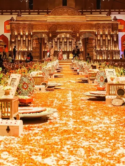 The 180-foot long aisle, lined with a stunning floral garden and decorated with hand-picked wooden props, creating a grand path for the couple.