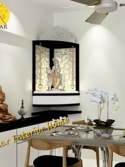 An elegant corner pooja unit in a black and white finish. The design uses hanging chains and backlighting to create a divine aura, and it sits atop a matching sideboard for extra storage.