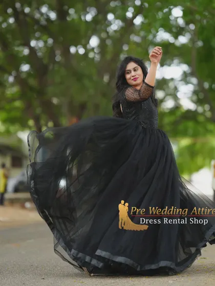 A twirling shot of the black tulle ball gown, showing the beautiful movement and sheer quality of the skirt.