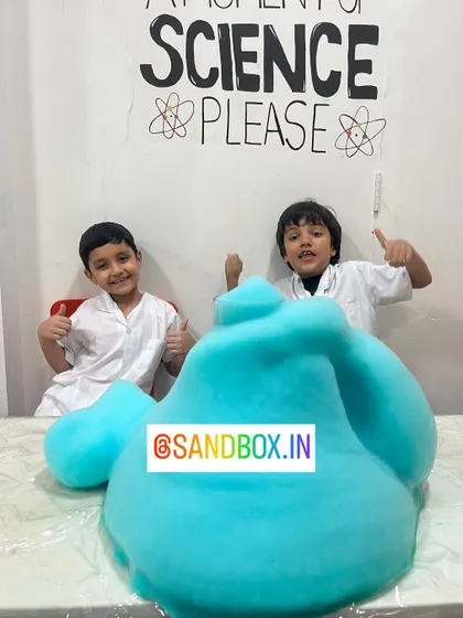 We love mixing up mysterious potions in our chemistry class. These two scientists are giving a big thumbs up after creating a massive blue foam eruption, learning about chemical reactions and catalysts.