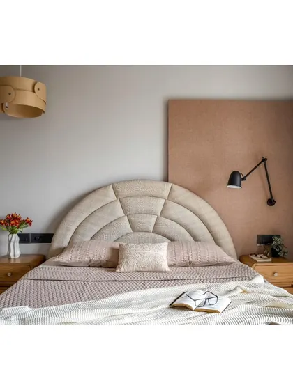 The guest bedroom features a unique, channel-tufted arched headboard and a warm, dusty rose color palette. I used different layers of lighting to create a space that feels cozy in the evening and fresh in the morning.