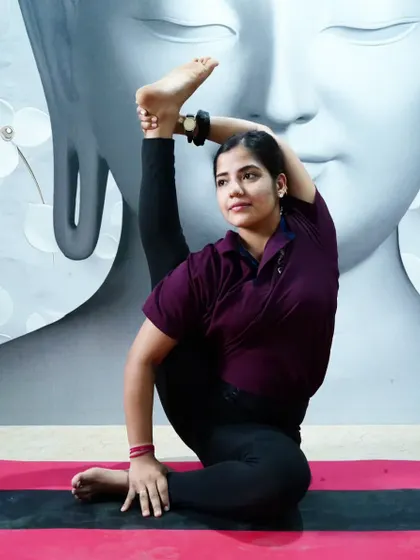 This standing compass pose, Parivrtta Surya Yantrasana, is a deep twist and hamstring stretch.