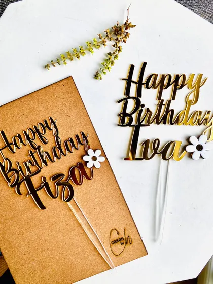 A side-by-side comparison of two custom birthday toppers, "Happy Birthday Fiza" and "Happy Birthday Iva," both featuring delicate floral accents.