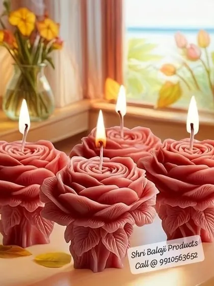 A stunning display of four lit rose pillar candles. These make for a beautiful and elegant decoration for any home or event.