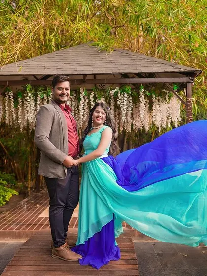 A classic pre-wedding photo in a gazebo, with the bride's flowing dress creating a beautiful visual.
