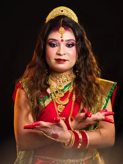 A student's artistic interpretation of the goddess Siddhidatri. The look features traditional makeup, jewellery, and expressive hand gestures, demonstrating skills in cultural and theatrical makeup.