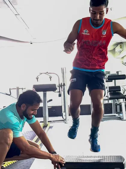 An athlete performs single-leg plyometric hops over a step. This develops unilateral power and stability, crucial for injury prevention and performance in sports that involve a lot of single-leg movements like bowling and running.
