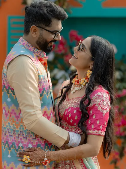 A sweet, candid moment between the couple at their Mehendi, sharing a look of love and happiness.