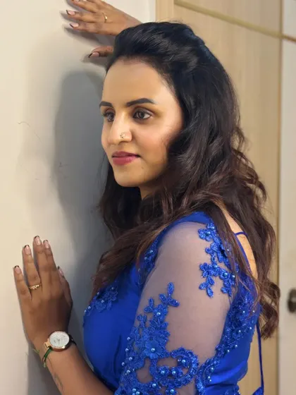 A side profile of my Navaratri Day 7 look, showing the sheer sleeve detail of the royal blue gown.