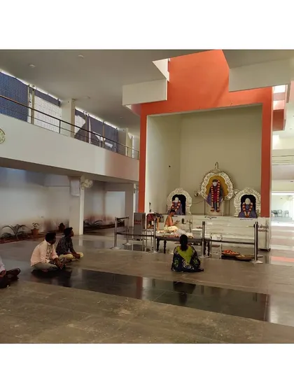 The main prayer hall at the Sai Temple in Trichy. The space is designed to be simple and serene, with a double-height volume that creates a sense of reverence and peace.
