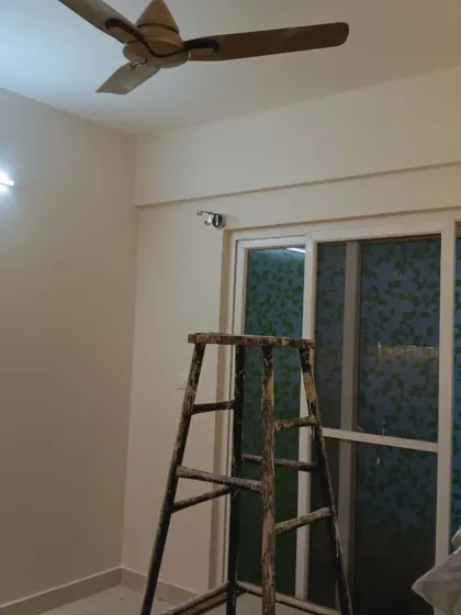 A room prepped for painting, with a ladder in place. This shows a typical setup before our team begins transforming the space with a fresh coat of paint.