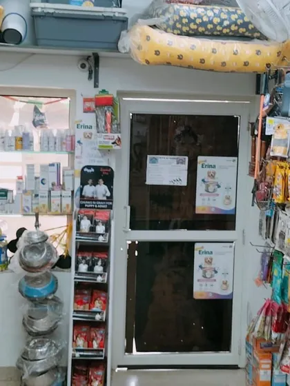 A view of the shop showing the wide range of products available, from feeding bowls and grooming supplies to treats hanging on the wall.