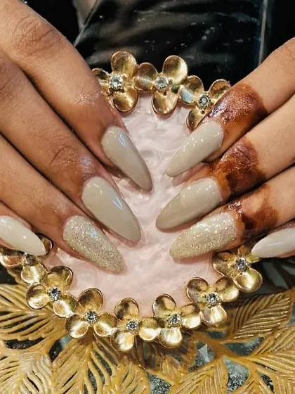 Nude and glitter nail extensions for a bride, showing how a subtle design can beautifully complement traditional henna.