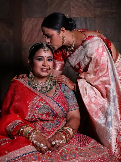 A mother's love captured in a tender moment as she kisses her daughter's forehead before the wedding ceremony.