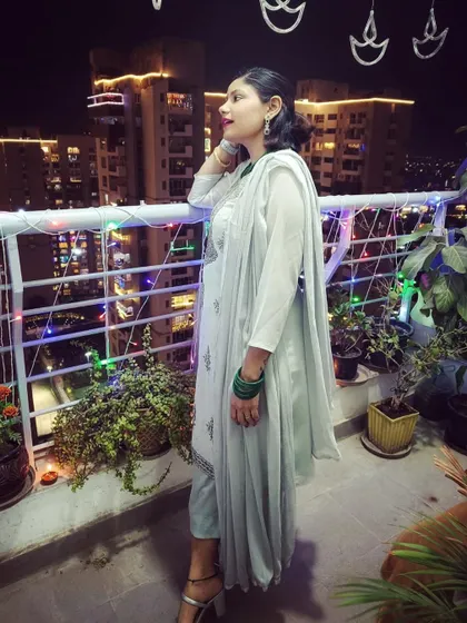 A serene Diwali moment on the balcony, overlooking the city lights. I chose a simple and elegant light green kurta set, which felt perfect for a quiet, festive evening at home.