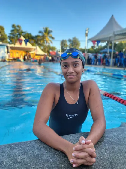 Samanvi E.S relaxing at the pool edge after her race.