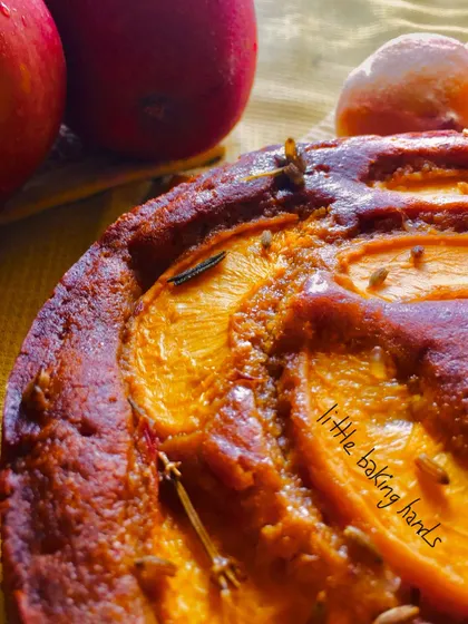 A close-up of a peach cake with fennel seeds, which add a lovely, subtle anise flavour. I love experimenting with these unique combinations.