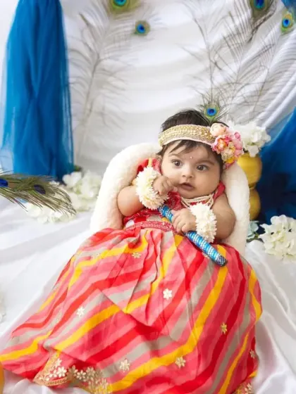 Holding a little flute, this baby girl is perfectly in character as Radha. It's all about capturing the spirit of the festival in a fun, baby-friendly way.