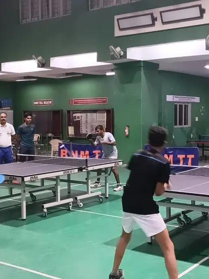 Players enjoying a practice session on our newly inaugurated professional-grade table, part of our commitment to providing top-tier facilities.