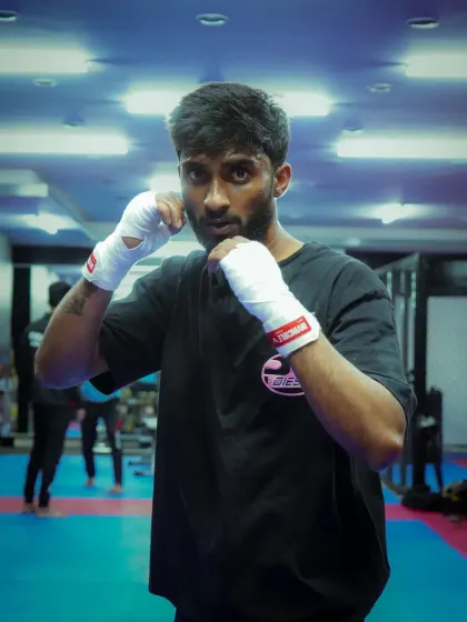 The intensity of a boxer, focused and ready to throw a punch. Our training builds both physical strength and mental fortitude.