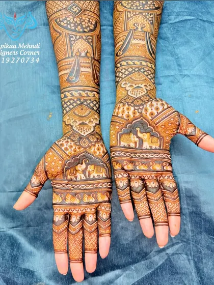 Another angle of a beautiful, non-figurative bridal design. This view highlights the intricate elephant motifs on the palms and the detailed architectural work on the forearms.