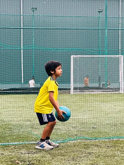 A player practices holding the ball. Even simple exercises help in building familiarity and control.