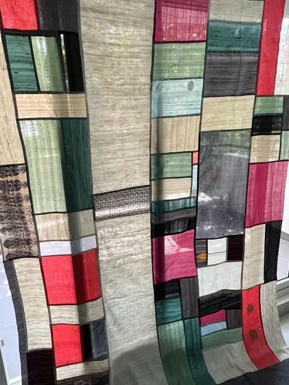 An angled view of the Pojagi divider, showing its scale and artistry.
