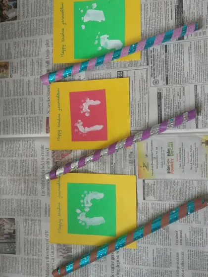 Handmade cards and decorated flutes for Janmashtami. The children's creations are a key part of the celebration, showing their engagement and learning.