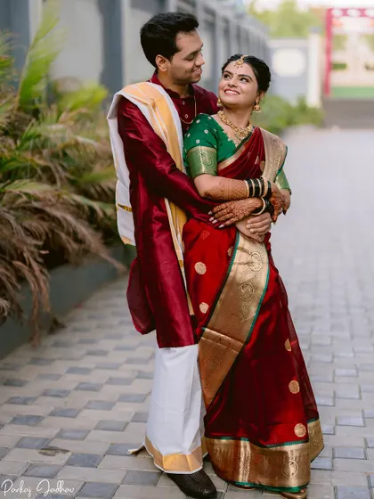 A classic portrait of the couple in their beautiful red and green traditional Maharashtrian wedding outfits.