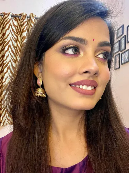 A side view showcasing the shimmer and dimension of the eye makeup. The gold reflects the light beautifully, making the eyes sparkle.