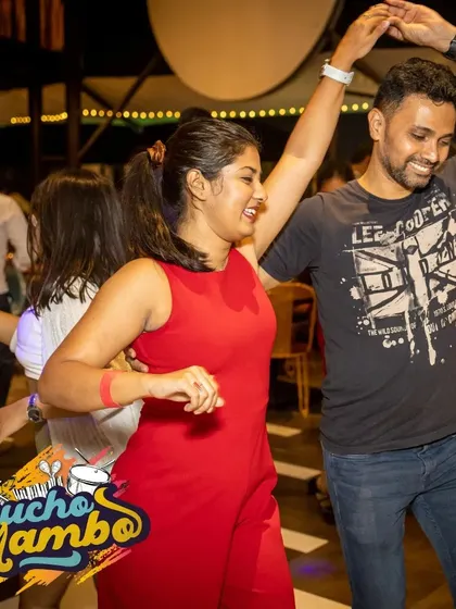 A dynamic trio enjoying a fast-paced song. The community aspect is strong, and it's common to see friends dancing together in groups.