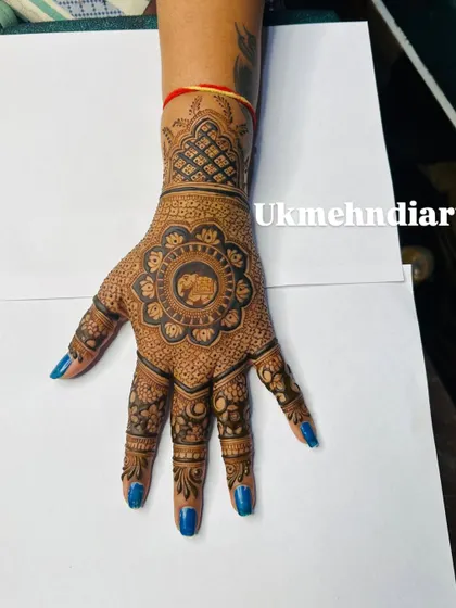 A full view of the elephant mandala design, showing the detailed finger work and the jaali pattern on the wristband.