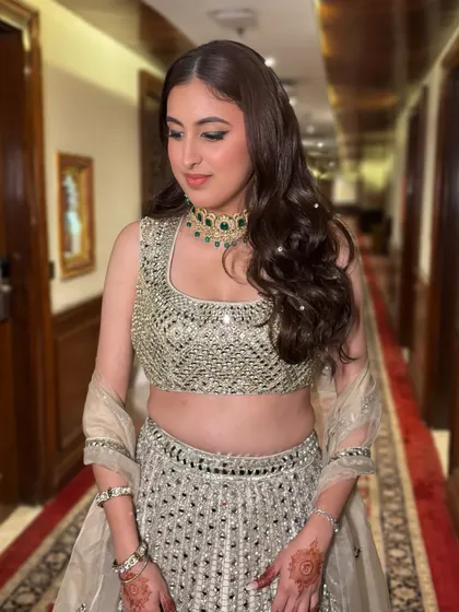 For Kriti's engagement, we did something fun and modern. I added a statement green liner to her soft glam makeup to match her jewelry, paired with glossy lips for a fresh, trendy look.