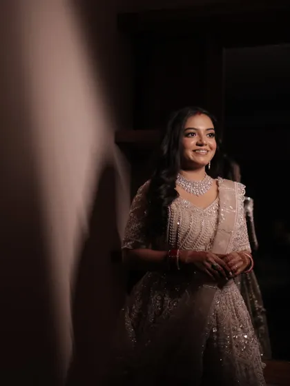 A stunning portrait of the bride, her reception makeup looking sophisticated and elegant in soft lighting.