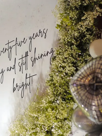 Personalized backdrops tell a story. For this 75th birthday, we included a custom sign with the message "Seventy-five years young and still shining bright," adding a heartfelt and personal touch to the glamorous photo corner.