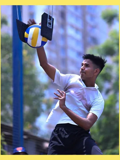 A player makes contact with the ball on the spike trainer, a perfect snapshot of power and precision.