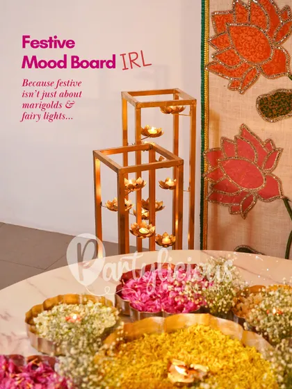 This is my festive mood board brought to life. I believe festive decor is more than just marigolds; it's about combining elements like these multi-tiered diya stands with floral arrangements for a sophisticated look.