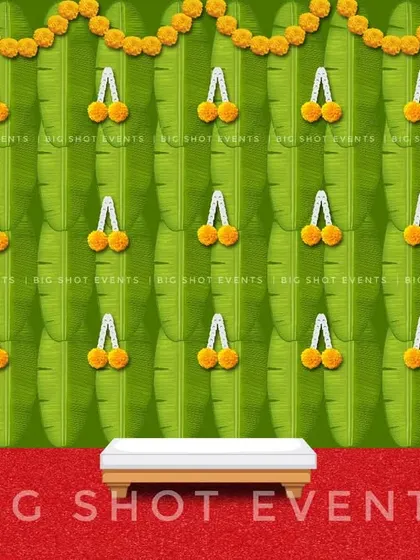 A simplified version of our banana leaf backdrop concept. This digital preview shows a clean green backdrop with marigold flower tassels, perfect for a variety of traditional ceremonies.