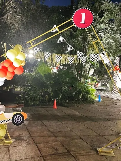A finish line arch marks the end of the party course, creating a fun and thematic exit for guests at this outdoor race car event in Mysore.