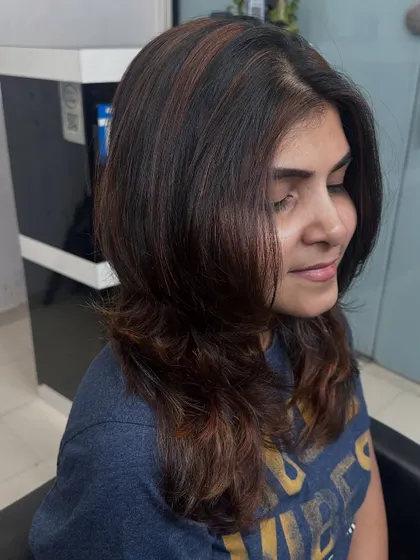 A side profile of the lovely copper brown highlights. You can see how the color frames her face and adds warmth to her overall look.