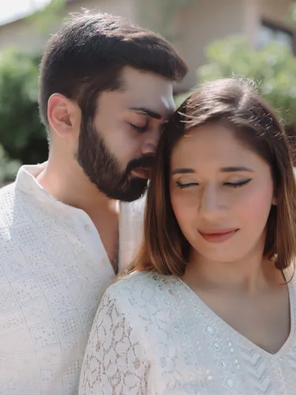 A close-up, intimate portrait of the couple, their eyes closed as they share a quiet moment, highlighting their deep connection.