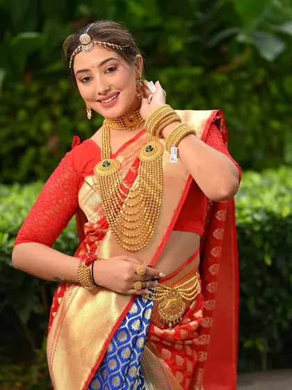A beautiful model in a traditional South Indian bridal look for a jewellery campaign. The vibrant red and blue saree makes the gold jewellery pop.