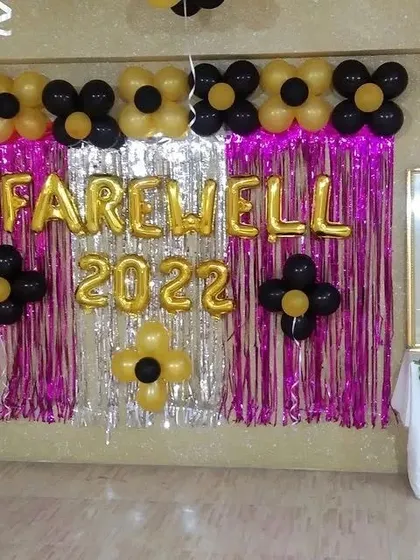 A straight-on view of the farewell backdrop, highlighting the combination of the shiny foil curtain and the matte finish of the balloons.